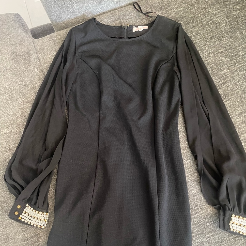 A nice black dress with sleeves that are open (showing arms)